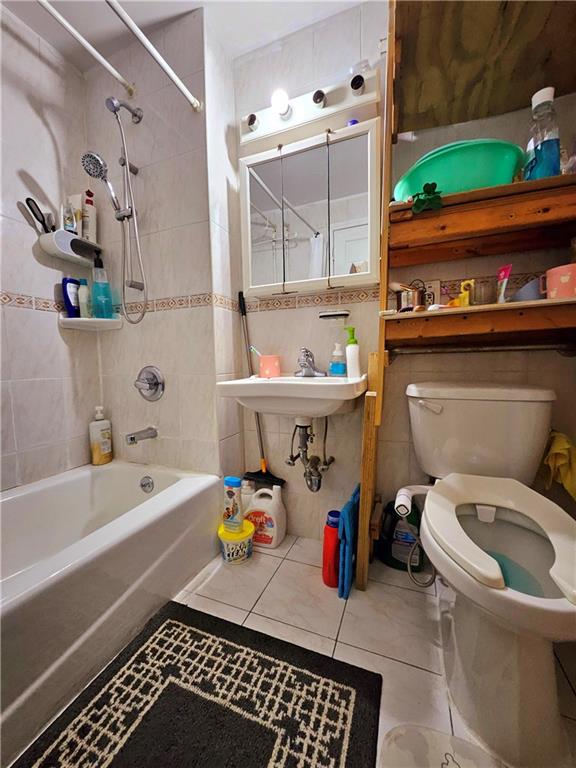 1820 73rd St Unit 1A, Brooklyn, NY 11214 - bathroom featuring shower / bathtub combination, tile patterned floors, and tile walls