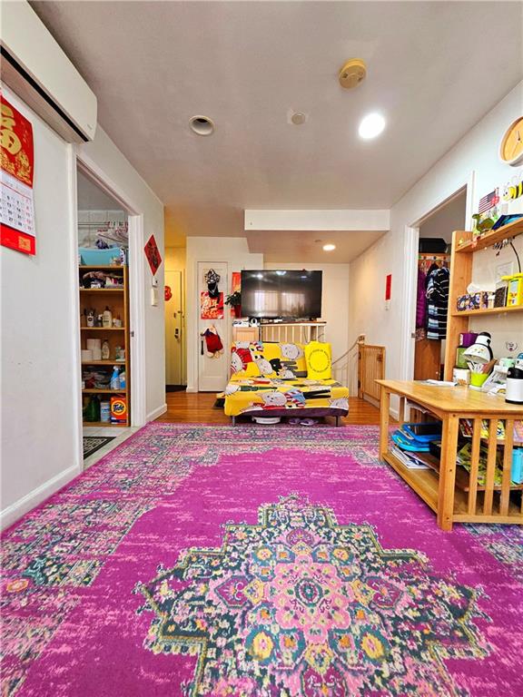 1820 73rd St Unit 1A, Brooklyn, NY 11214 - playroom with an AC wall unit and recessed lighting