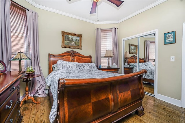 bedroom with multiple windows, wood finished floors, and ornamental molding