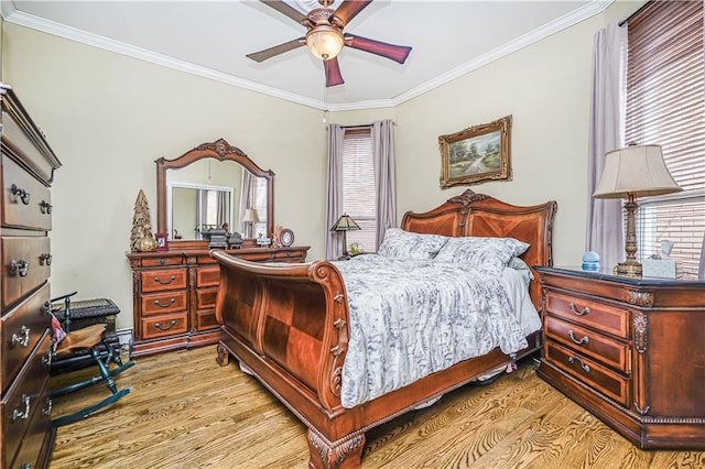 bedroom with light wood-type flooring, a ceiling fan, and crown molding