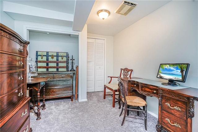 office area featuring visible vents, baseboards, and carpet flooring