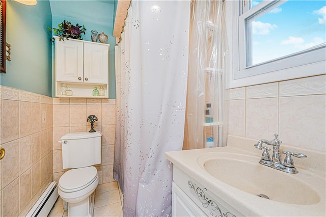 bathroom with toilet, a baseboard heating unit, tile walls, tile patterned flooring, and vanity