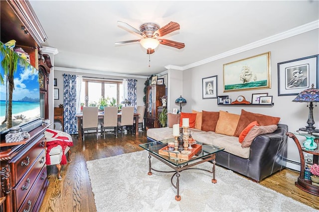 living room with ceiling fan, wood finished floors, and crown molding