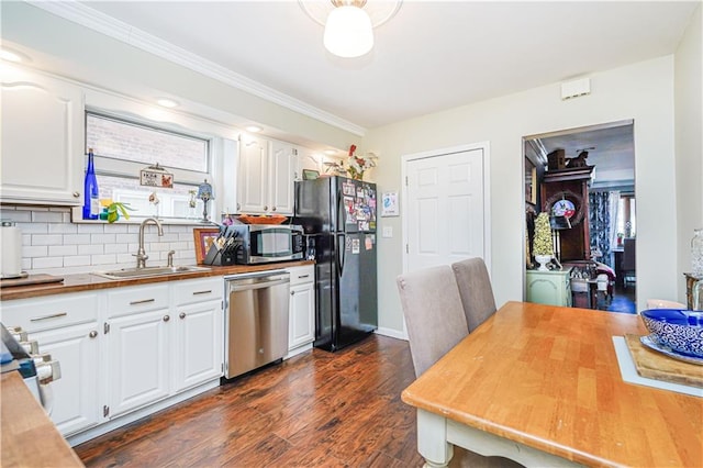 kitchen featuring a sink, stainless steel appliances, dark wood-type flooring, backsplash, and butcher block counters