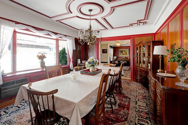 dining space with a chandelier, dark wood-style floors, and crown molding