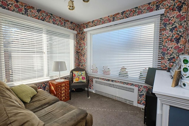 sitting room with baseboards, radiator, wallpapered walls, and carpet