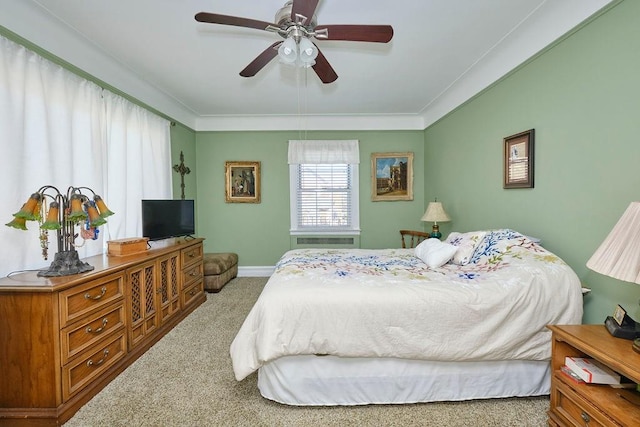 carpeted bedroom featuring baseboards and ornamental molding