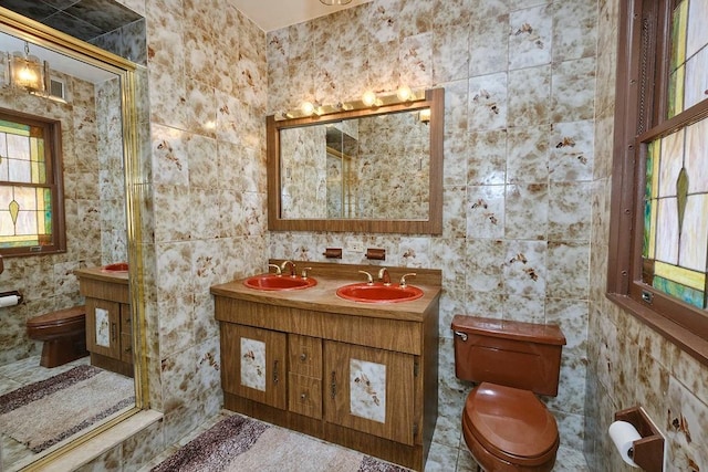 full bath with toilet, a wealth of natural light, and a sink