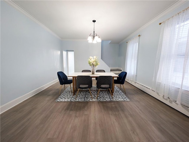 dining room featuring dark wood finished floors, crown molding, and baseboards