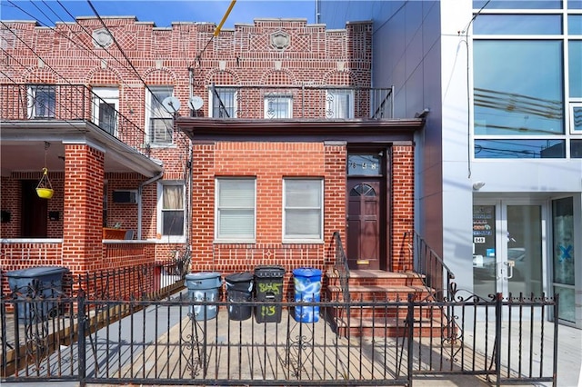 view of front of property with brick siding and a fenced front yard