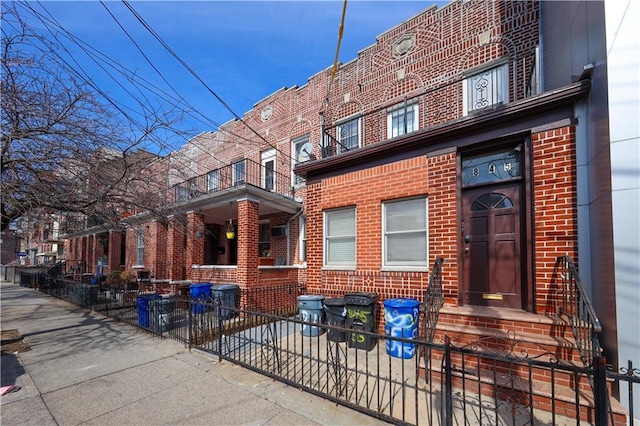 exterior space featuring fence and brick siding