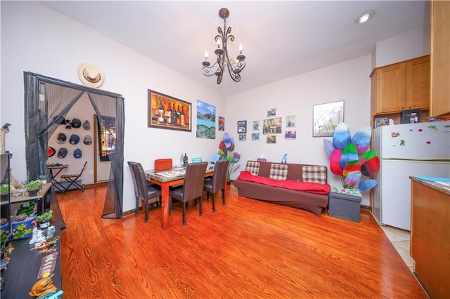 dining area featuring a notable chandelier and light wood finished floors