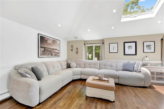 living area featuring recessed lighting, wood finished floors, vaulted ceiling with skylight, and a baseboard radiator