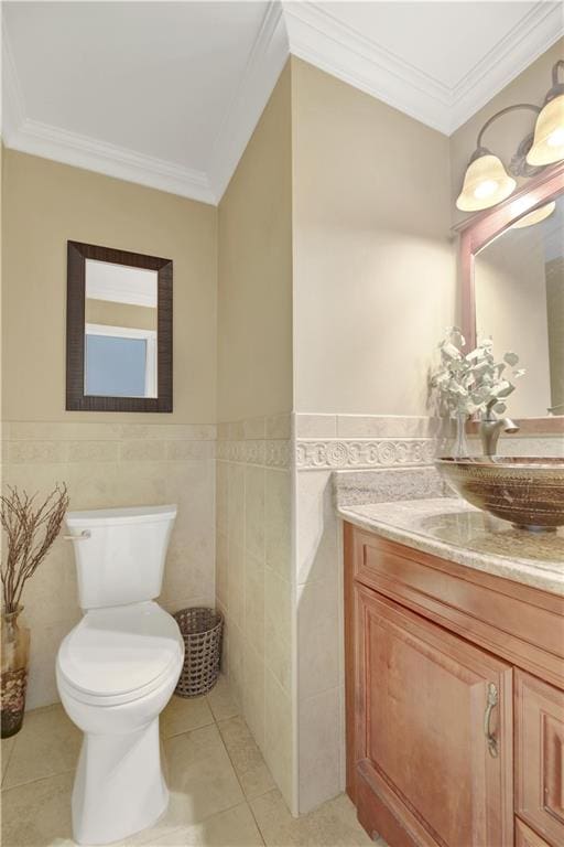 bathroom featuring tile patterned flooring, toilet, tile walls, and crown molding