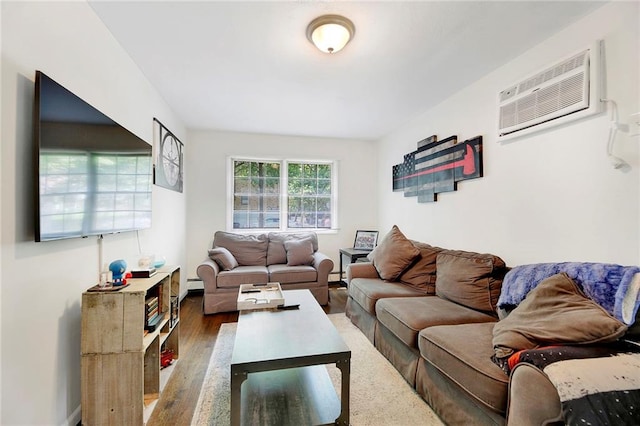 living area with baseboard heating, wood finished floors, and a wall mounted air conditioner