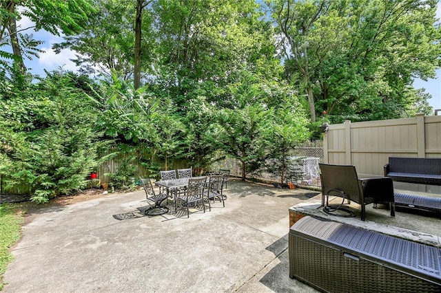 view of patio with an outdoor living space, outdoor dining area, and a fenced backyard