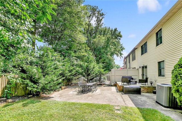 view of yard with outdoor lounge area, cooling unit, a patio area, and fence