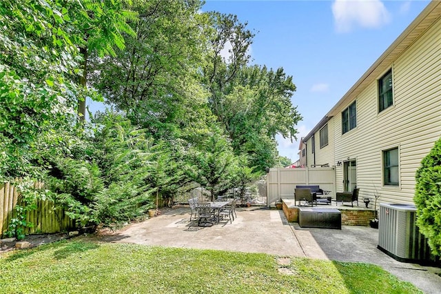 view of yard featuring a patio, central AC unit, and fence