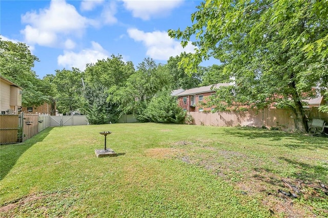 view of yard featuring a gate and a fenced backyard