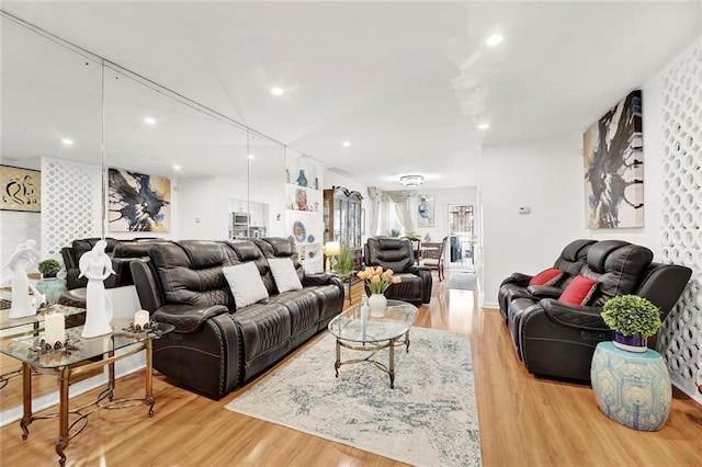 living room with recessed lighting and wood finished floors