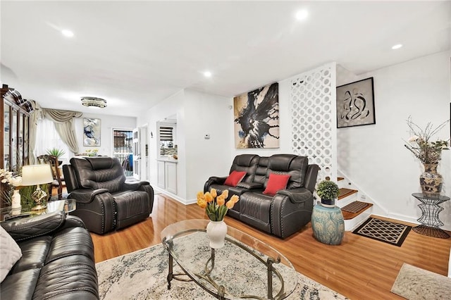 living area featuring recessed lighting, baseboards, and wood finished floors