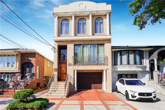 view of front of house featuring brick siding, an attached garage, and driveway