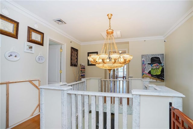 hallway featuring visible vents, ornamental molding, an upstairs landing, wood finished floors, and a notable chandelier