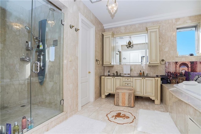 bathroom featuring a sink, tile walls, a shower stall, double vanity, and a bath