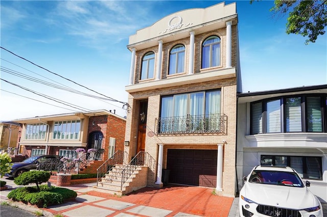 view of front of house featuring an attached garage and brick siding