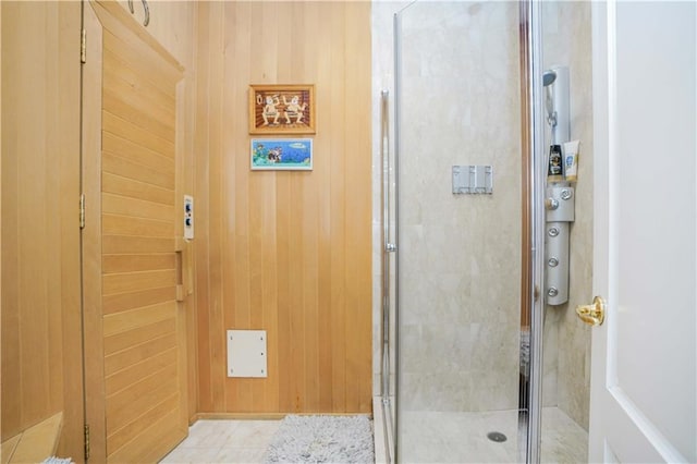 bathroom with wooden walls and a shower stall