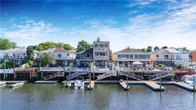 view of dock featuring a water view and a residential view