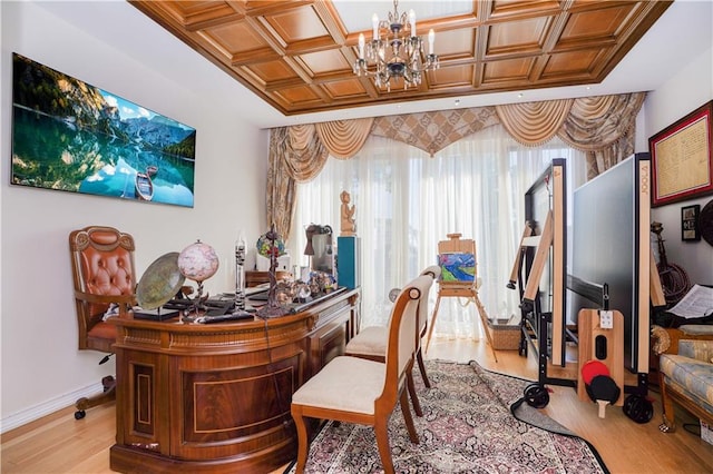 home office featuring a notable chandelier, coffered ceiling, light wood-style floors, and baseboards