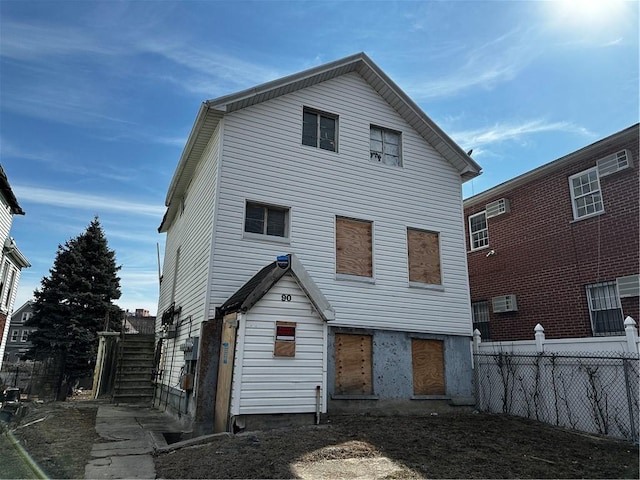 rear view of house with fence