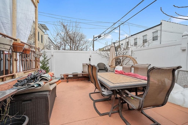 view of patio featuring outdoor dining space and fence private yard