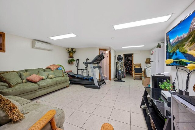 living room featuring light tile patterned floors and a wall mounted air conditioner