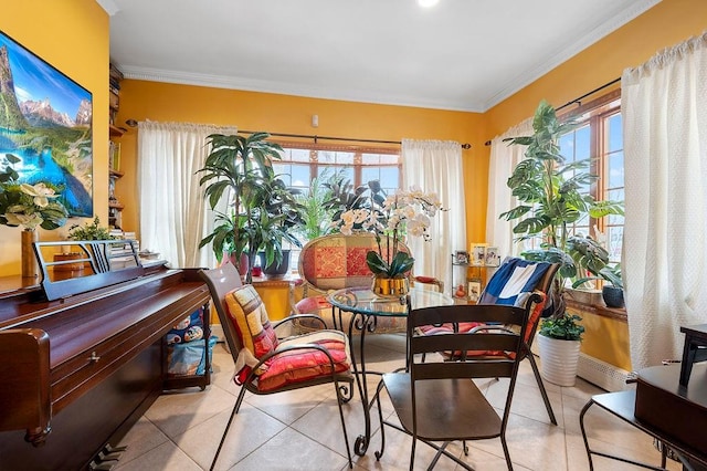 tiled dining space featuring crown molding and a healthy amount of sunlight