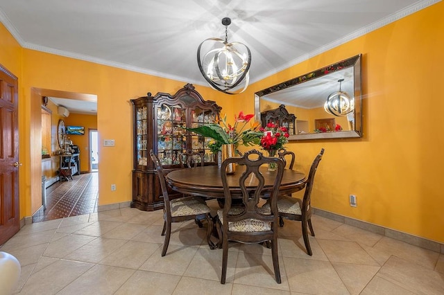 dining area featuring crown molding, baseboards, tile patterned floors, and a chandelier