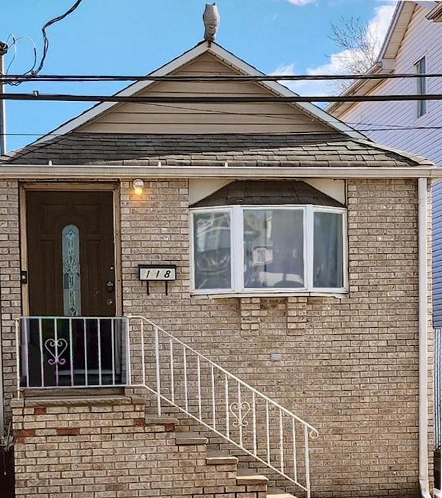 view of exterior entry featuring brick siding