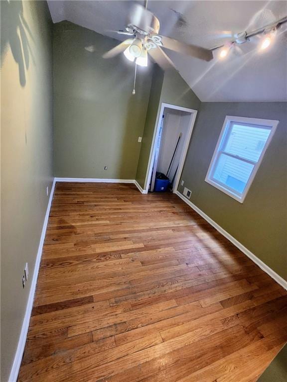 bonus room featuring vaulted ceiling, wood finished floors, baseboards, and ceiling fan