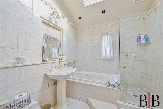 full bathroom featuring walk in shower, lofted ceiling, a garden tub, and tile walls