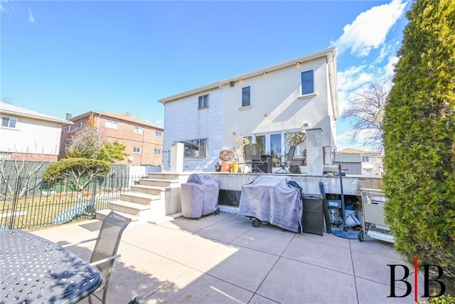 back of property with a patio and fence