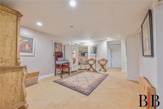 living area with recessed lighting, concrete flooring, and baseboards