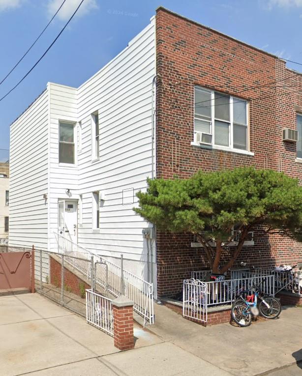 view of front of home with cooling unit and fence