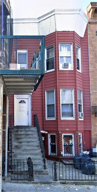 368 54th St, Brooklyn, NY 11220 - view of front of house with a fenced front yard and cooling unit