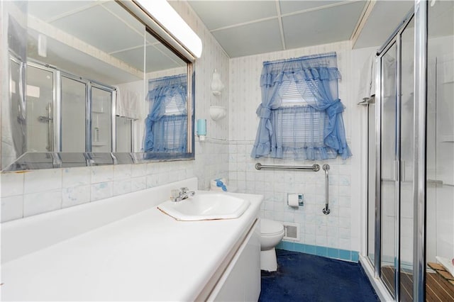 full bath featuring visible vents, a shower stall, wallpapered walls, toilet, and tile walls