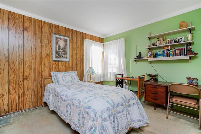 bedroom with carpet, wood walls, and crown molding