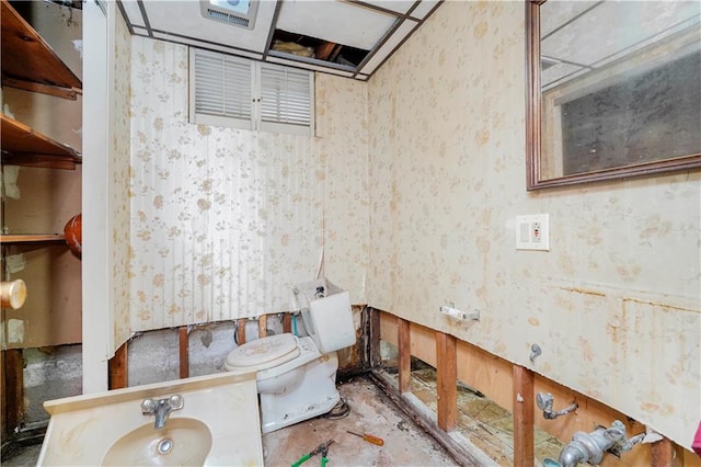 half bathroom featuring toilet and wallpapered walls