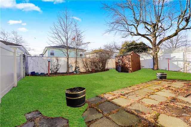 view of yard featuring a fenced backyard, a patio area, a storage shed, and an outdoor structure