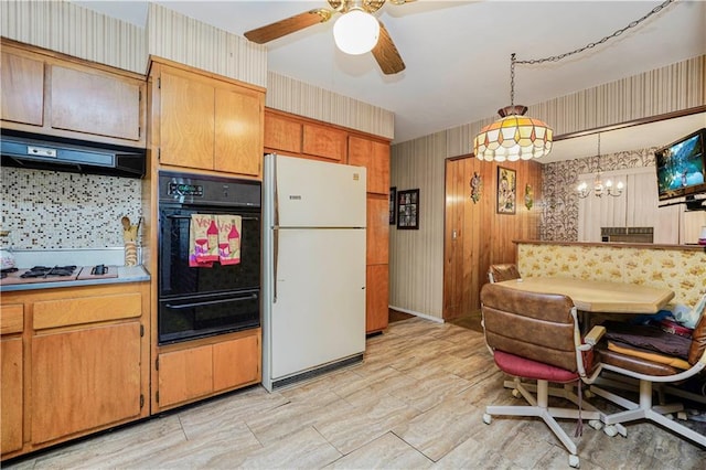 kitchen featuring under cabinet range hood, white appliances, wallpapered walls, and a warming drawer