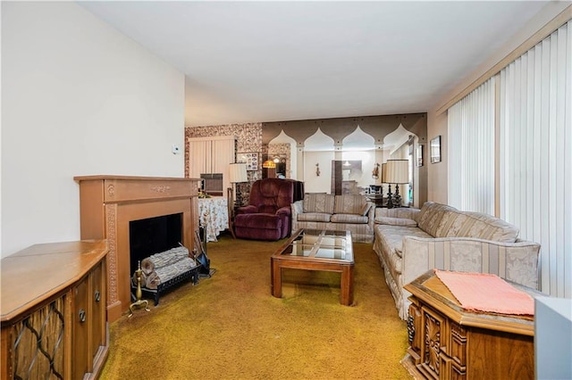 living room featuring carpet, a fireplace, and wallpapered walls